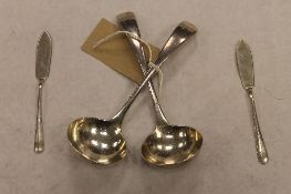 A pair of silver sauce spoons, together with a pair of silver butter knives. (4) CONDITION REPORT: