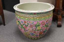 A Chinese jardiniere, decorated with dragons and foliage on pink ground, diameter 53 cm. CONDITION
