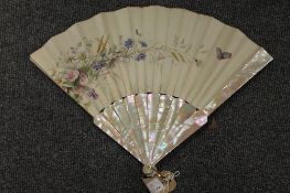 A French silk and mother of pearl fan, boxed. CONDITION REPORT: Good condition, with Paris labels to
