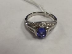 A platinum tanzanite ring set with diamonds.
