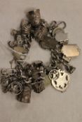 An early twentieth century silver charm bracelet, 156g. CONDITION REPORT: Good condition,