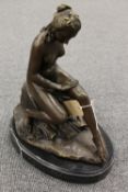 After C. Allagrain - bronze study of a Lady seated on rocks on black marble plinth, height 32