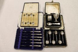 A silver egg cup, napkin ring and teaspoon set, together with two sets of silver teaspoons and a set
