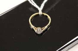 An 18ct gold diamond solitaire ring, with diamond shoulders. CONDITION REPORT: Good condition
