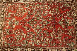 An Iranian wool rug, on red ground, 144 cm x 100 cm.