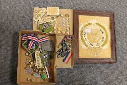 A collection of military badges, buttons, together with a framed embroidered panel. (Q) CONDITION