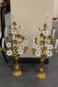 A pair of early twentieth century French gilt-brass and opaline glass candelabra, with gothic