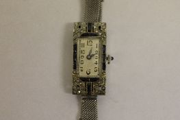 A Lady's platinum cocktail watch set with sapphires and diamonds.