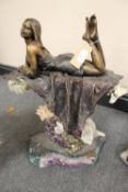 An Ebano Vidal bronze and rock crystal sculpture - A Lady laying upon a carpet, width 39 cm.