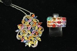 A white metal ring and pendant, each set with precious and semi-precious stones. (2) CONDITION