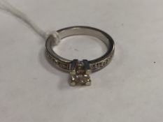 An 18ct white gold diamond ring set with diamond shoulders.