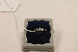 An 18ct gold platinum set three stone diamond ring. CONDITION REPORT: Good condition.