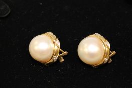 A pair of 18ct gold large mabe pearl earrings, each set with diamonds. (2) CONDITION REPORT: Good