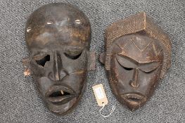A pair of African carved wooden masks. (2) CONDITION REPORT: Good condition, small knocks and