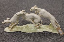 H. Achtziger for Hutschenreuther : A study of three whippets, on naturalistic base, width 49 cm.