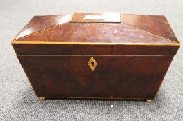 A nineteenth century inlaid mahogany tea caddy, on brass ball feet, with 28 cm. CONDITION REPORT: