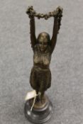 After D.H. Chiparus - bronze study of a Lady with arms raised holding flowers, on a black marble