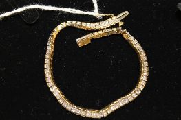 An 18ct gold seventy-one stone princess cut diamond bracelet, approximately 5ct, 17.4g, length 19