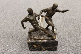 A bronze study of two football players on marble plinth, height 23 cm.  CONDITION REPORT: Good
