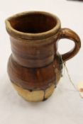 A pottery part-glazed jug, probably sixteenth century, height 22.5 cm. CONDITION REPORT: Good