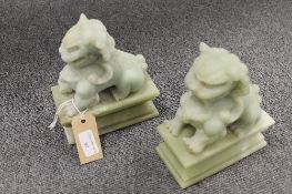 A pair of Chinese green stone figures depicting Fu dogs, height 18 cm. CONDITION REPORT: Good