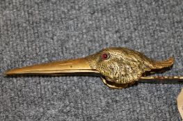 A French bronze clip, modelled as a bird's head, with ruby eyes, length 17 cm. CONDITION REPORT:
