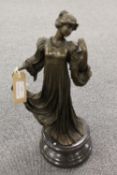 After A. Leonard - A Lady in a long dress clutching an apple on black marble socle. Height 38 cm.