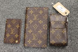 A Louis Vuitton address wallet, together with a card holder and cigarette holder. (3)  CONDITION