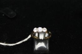 An 18ct gold three stone diamond ring, 3.3g. CONDITION REPORT: Good condition.