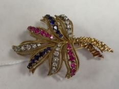An 18ct gold diamond and sapphire leaf brooch.
