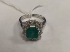 An 18ct white gold emerald and diamond ring set in platinum.
