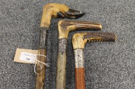 Three late nineteenth century horn and hoof walking sticks, each mounted in white metal. (3)