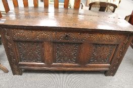 An eighteenth century carved oak coffer, width 132cm.