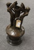 A bronze study of a vase surmounted by flower fairies, on black marble socle, height 38 cm.
