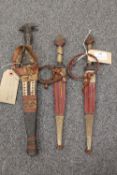 Three late nineteenth / early twentieth century tribal daggers in scabbards. (3) CONDITION REPORT: