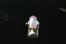 An 18ct white gold Art Deco style opal ring. CONDITION REPORT: Very small nibble to the edge of