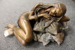 A bronze and rock crystal sculpture - Lady resting upon pillows, width 43 cm. CONDITION REPORT: Some