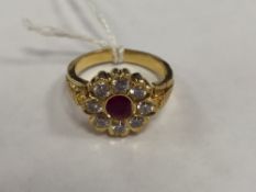 A 22ct gold ruby and diamond cluster ring.