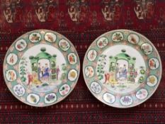 A pair of Chinese famille verte plates, the borders decorated with butteflies and foliage,