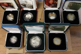 A Royal Mint silver proof piedfort two pound coin celebrating DNA, together with six other silver