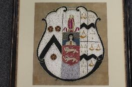 A nineteenth century embroidered heraldic panel, framed, 28cm x 32cm, framed.