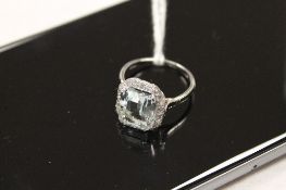An aqua marine and diamond ring. CONDITION REPORT: Unmarked but in white gold.
