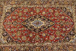 An Iranian wool carpet, on red ground, 169 cm x 104 cm.