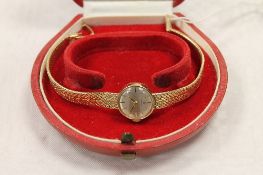 A 9ct gold lady's Omega wrist watch, 20.4g. CONDITION REPORT: Good condition, with original red