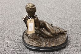 After Leon Becthux - bronze study of a reclining nude, on oval black marble plinth, height 26 cm.