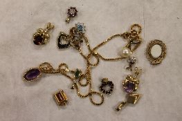 A collection of gold and yellow metal pendants, some set with diamonds, emeral and ruby. (Q)