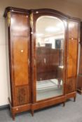 A early twentieth century ormulu mounted walnut triple door wardrobe, width 175cm.