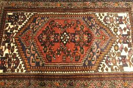 An Iranian wool rug, on red and cream ground, 142 cm x 97 cm.