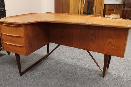 A mid twentieth century teak desk, width 150cm.