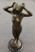 After Pitta Luga - bronze study depicting a lady holding her hair, on black circular plinth,